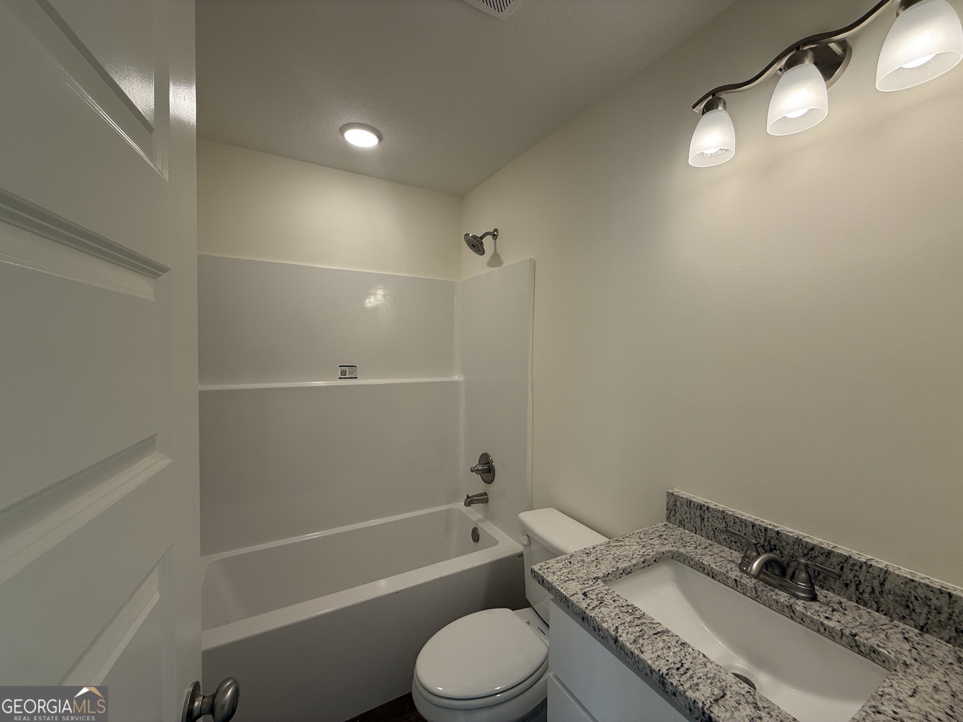 304 Womack Road South Portal, GA 30450 - Photo 16 of 19 a bathroom with a granite countertop sink toilet and shower