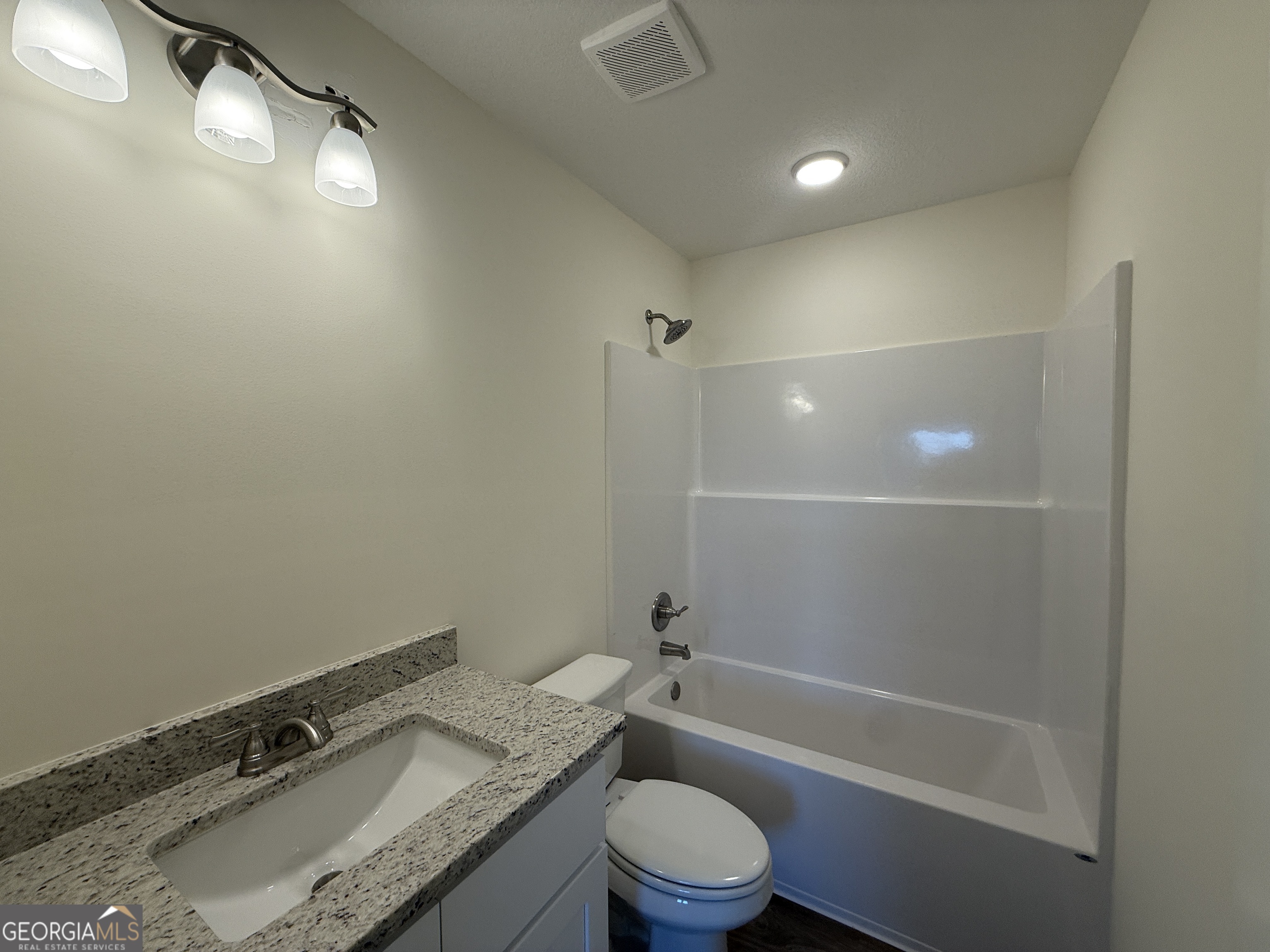 304 Womack Road South Portal, GA 30450 - Photo 18 of 19 a bathroom with a granite countertop sink a toilet and shower