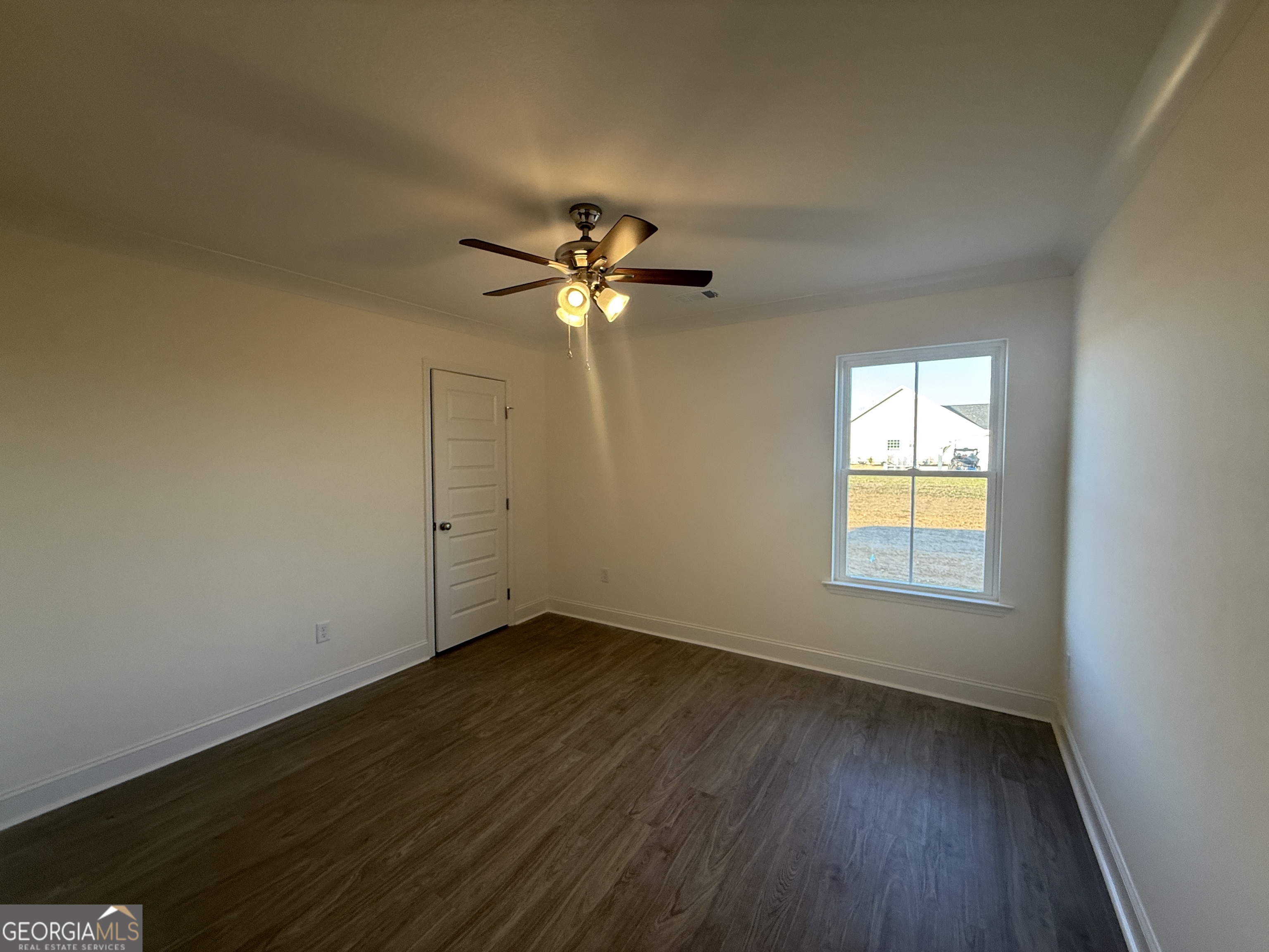 304 Womack Road South Portal, GA 30450 - Photo 19 of 19 an empty room with wooden floor and windows