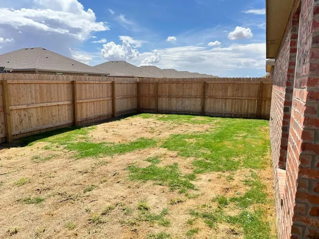 a view of a backyard of the house