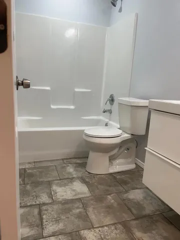 a bathroom with a toilet a sink and bathtub