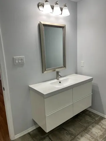 a bathroom with a sink and a mirror
