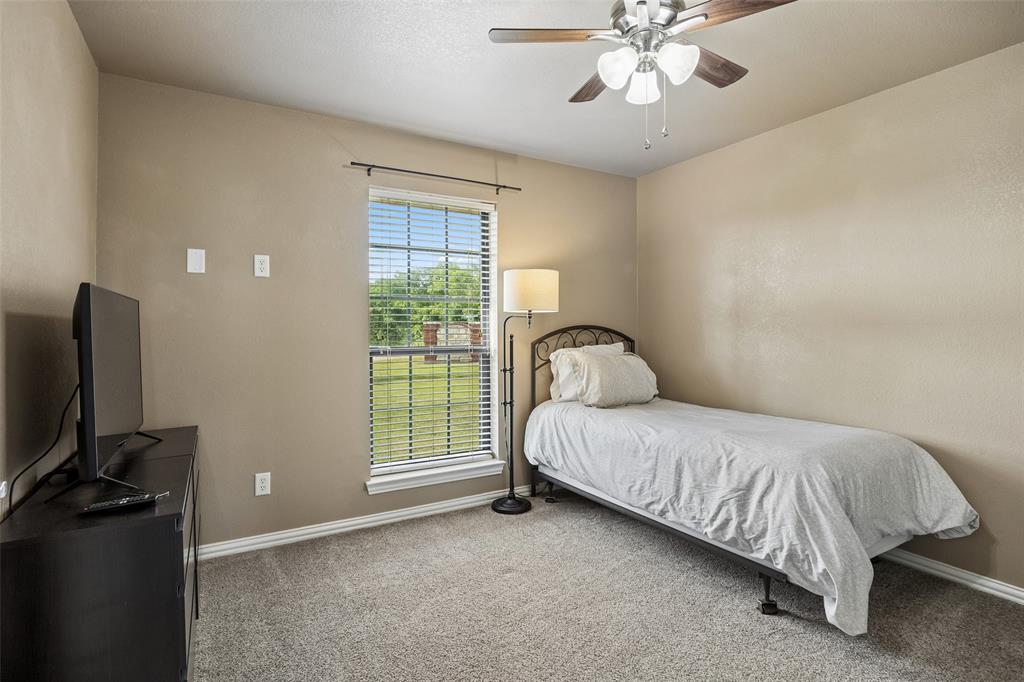 11211 Emerald Ranch Lane Forney, TX 75126 - Photo 28 of 35 Secondary bedroom #2 Carpeted room featuring a single window with blinds, a ceiling fan with light fixture, and neutral-toned walls