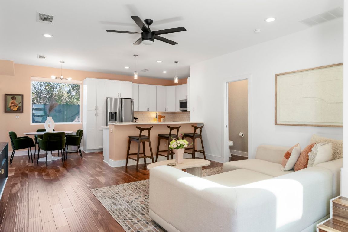 a living room with kitchen island furniture and a wooden floor