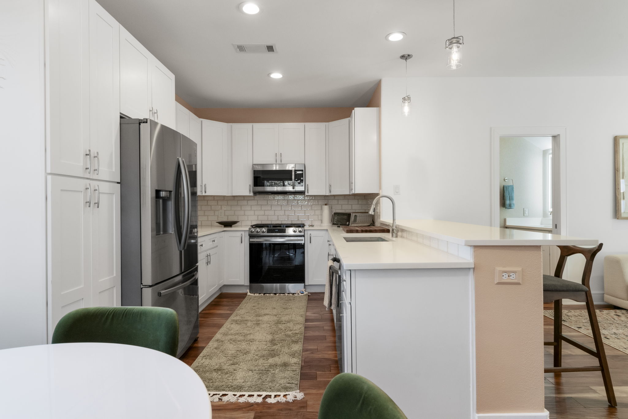 1148 Webberville Road, Unit 6 Austin, TX 78721 - Photo 12 of 34 a kitchen with stainless steel appliances a stove refrigerator sink and microwave