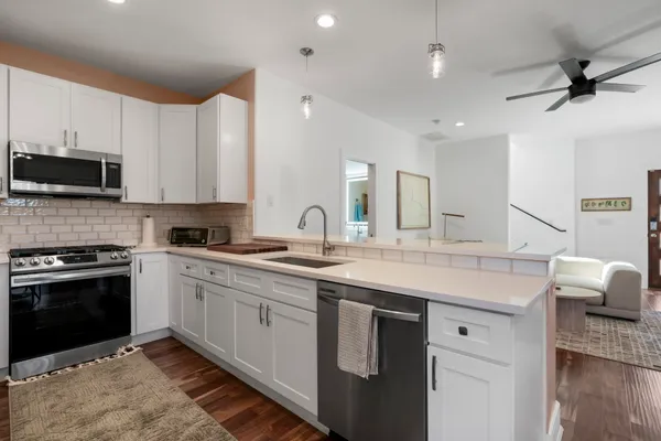 a kitchen with a sink stove and microwave