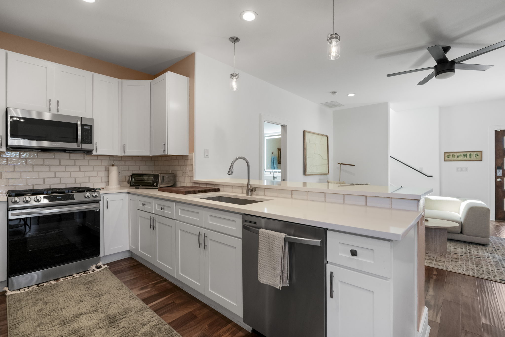 1148 Webberville Road, Unit 6 Austin, TX 78721 - Photo 13 of 34 a kitchen with a sink stove and microwave
