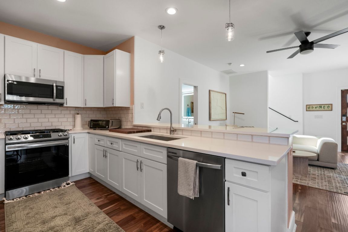 1148 Webberville Road, Unit 6 Austin, TX 78721 - Photo 13 of 34 a kitchen with a sink stove and microwave