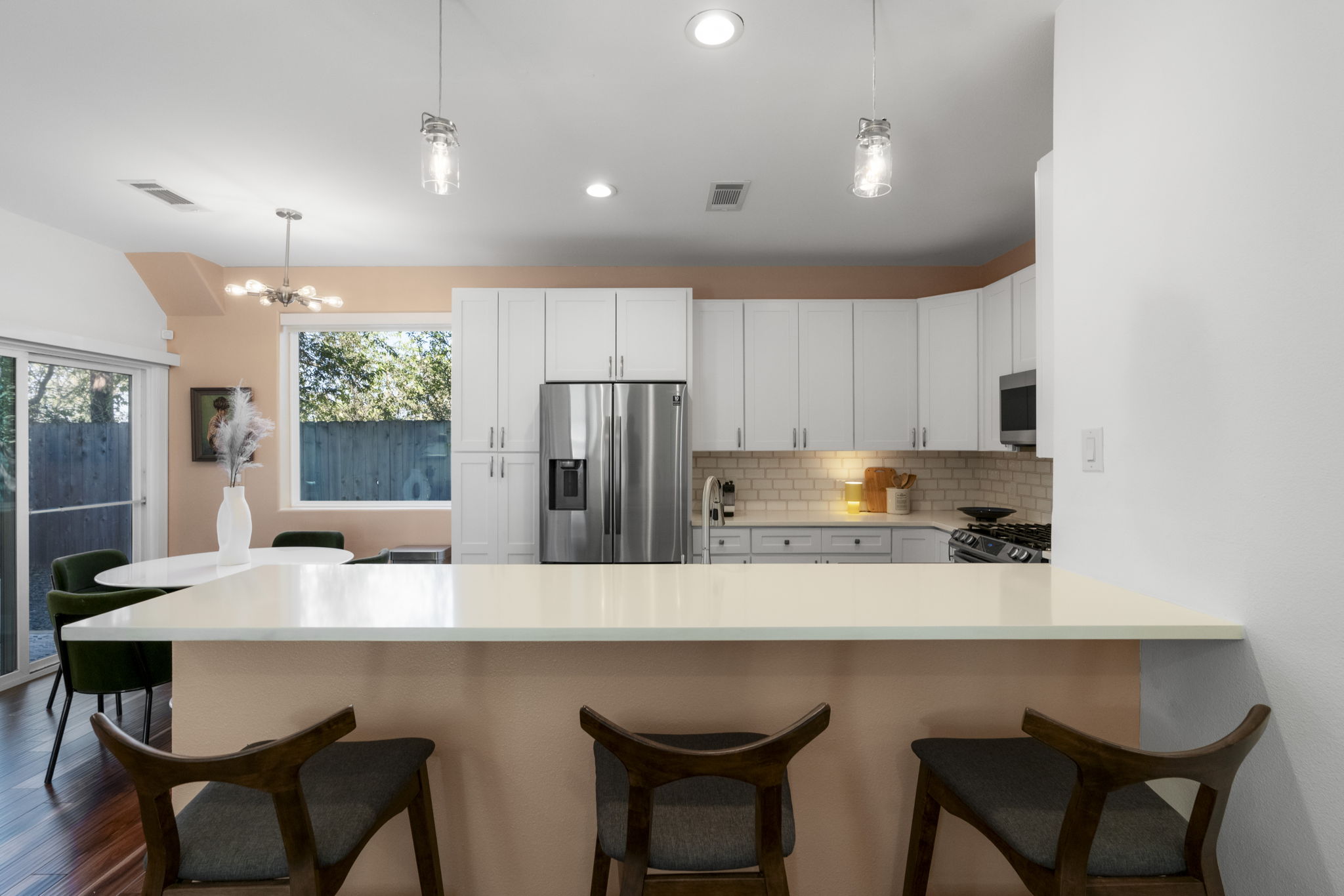 1148 Webberville Road, Unit 6 Austin, TX 78721 - Photo 14 of 34 a kitchen with stainless steel appliances a dining table and chairs