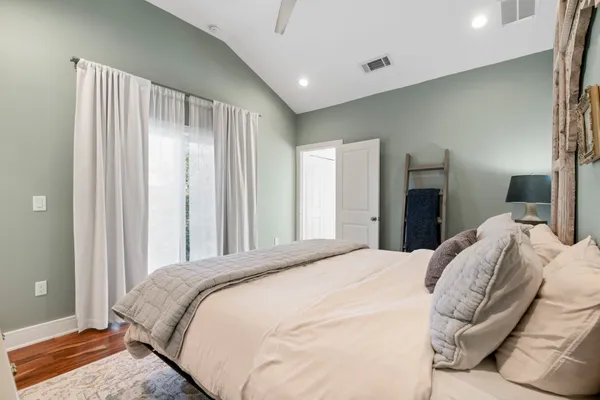 a bedroom with a bed and a large mirror