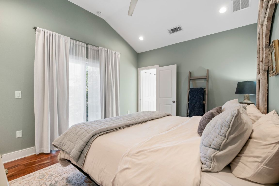 1148 Webberville Road, Unit 6 Austin, TX 78721 - Photo 19 of 34 a bedroom with a bed and a large mirror