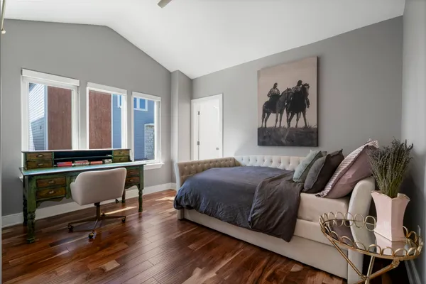 a bedroom with furniture and a large window