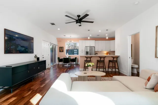 a living room with lots of furniture and view of kitchen