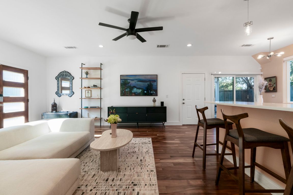 1148 Webberville Road, Unit 6 Austin, TX 78721 - Photo 8 of 34 a living room with furniture and a wooden floor