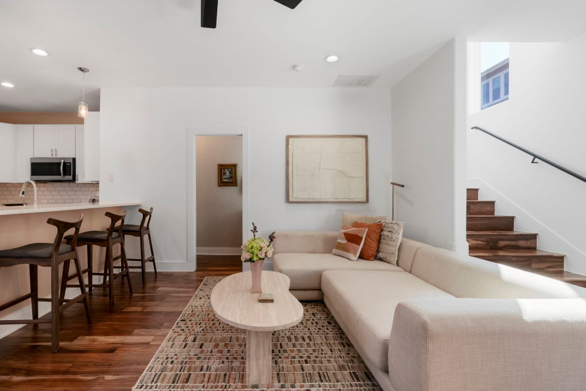 1148 Webberville Road, Unit 6 Austin, TX 78721 - Photo 9 of 34 a living room with furniture and wooden floor