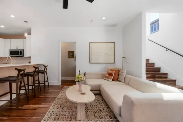 a living room with furniture and wooden floor