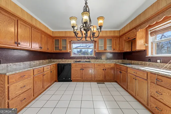 a kitchen with stainless steel appliances granite countertop a sink and cabinets