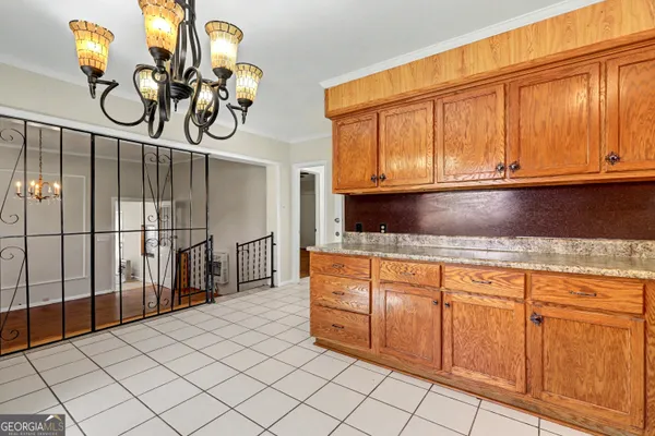 a kitchen with granite countertop a sink a stove and cabinets