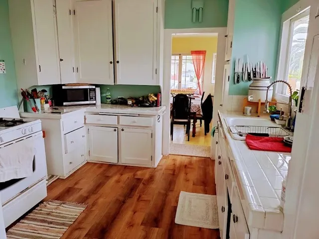 a kitchen with a refrigerator sink stove and cabinets