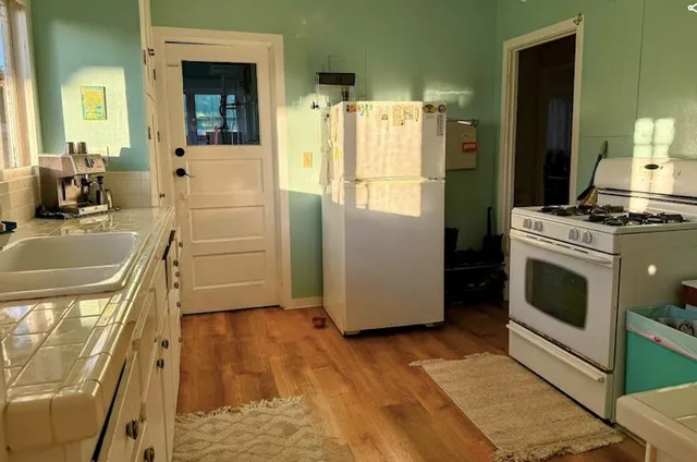 a bed sitting in a bedroom next to a window