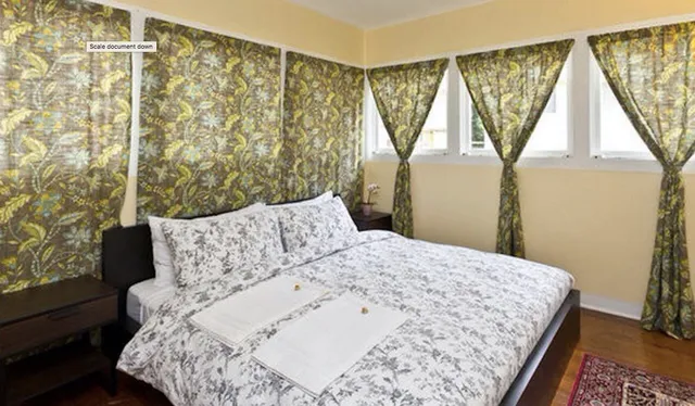 a bed sitting in a bedroom next to a window