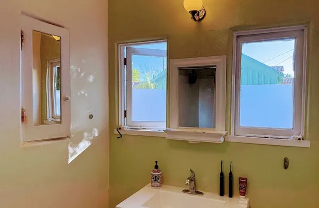 a view of a white house with a yard