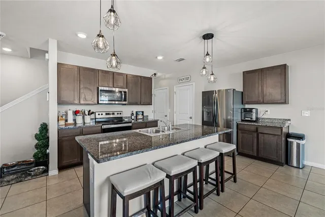 a kitchen with stainless steel appliances granite countertop a stove and a microwave
