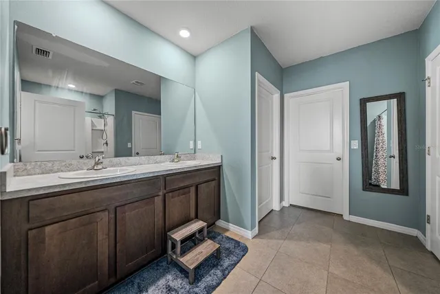a bedroom with furniture and flat screen tv