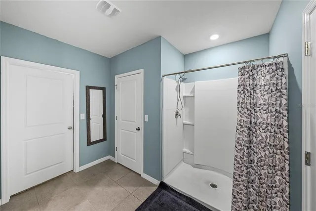 a bathroom with a double vanity sink toilet and shower