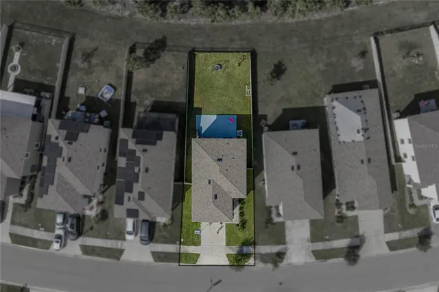 an aerial view of a house with a yard