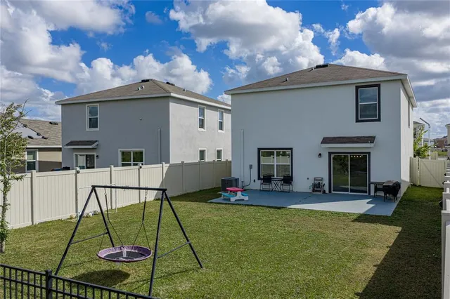 a view of a lake with lawn chairs and a table