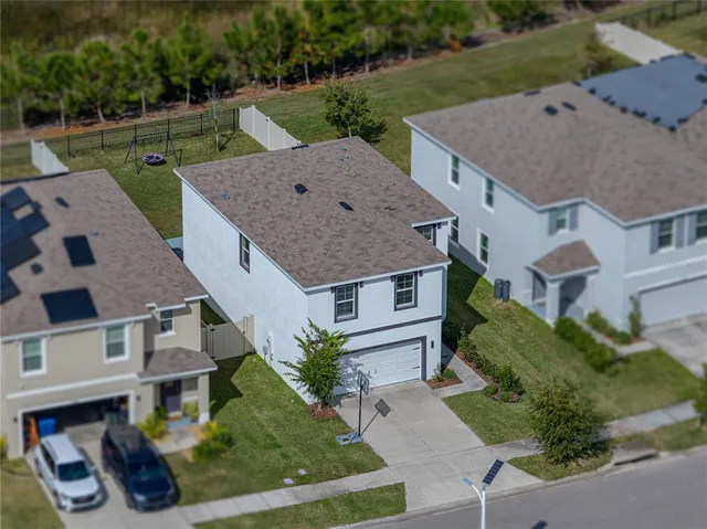 a front view of a house with a yard and a garage
