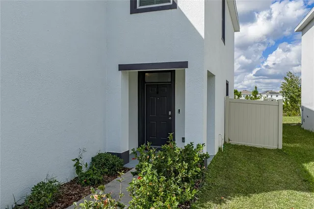 a living room with furniture and a book shelf