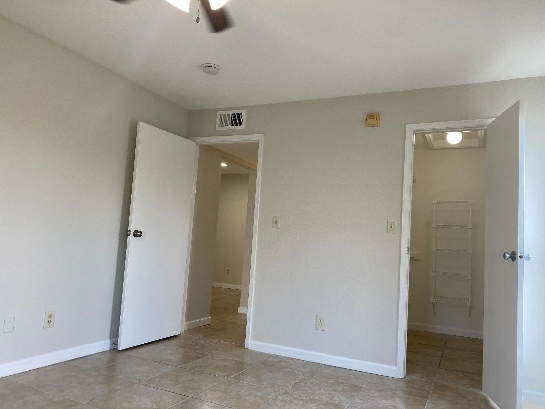 755 Riverside Drive, Unit 1337 Coral Springs, FL 33071 - Photo 25 of 37 an empty room with chandelier fan
