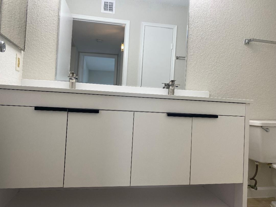 755 Riverside Drive, Unit 1337 Coral Springs, FL 33071 - Photo 26 of 37 a bathroom with a sink and a mirror