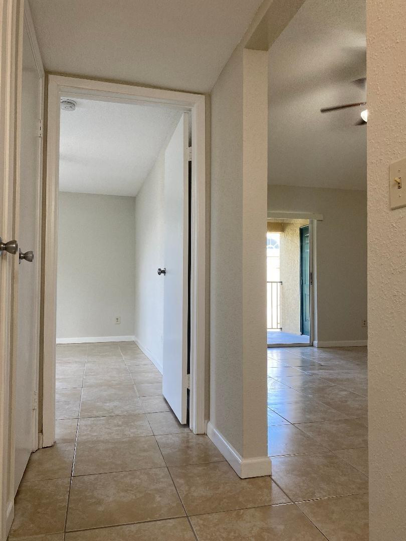 755 Riverside Drive, Unit 1337 Coral Springs, FL 33071 - Photo 28 of 37 a view of a hallway with wooden floor and a glass door