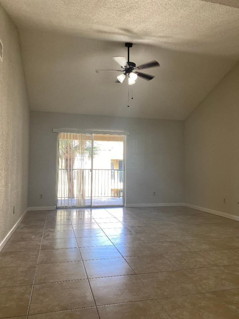 755 Riverside Drive, Unit 1337 Coral Springs, FL 33071 - Photo 5 of 37 an empty room with windows and fan