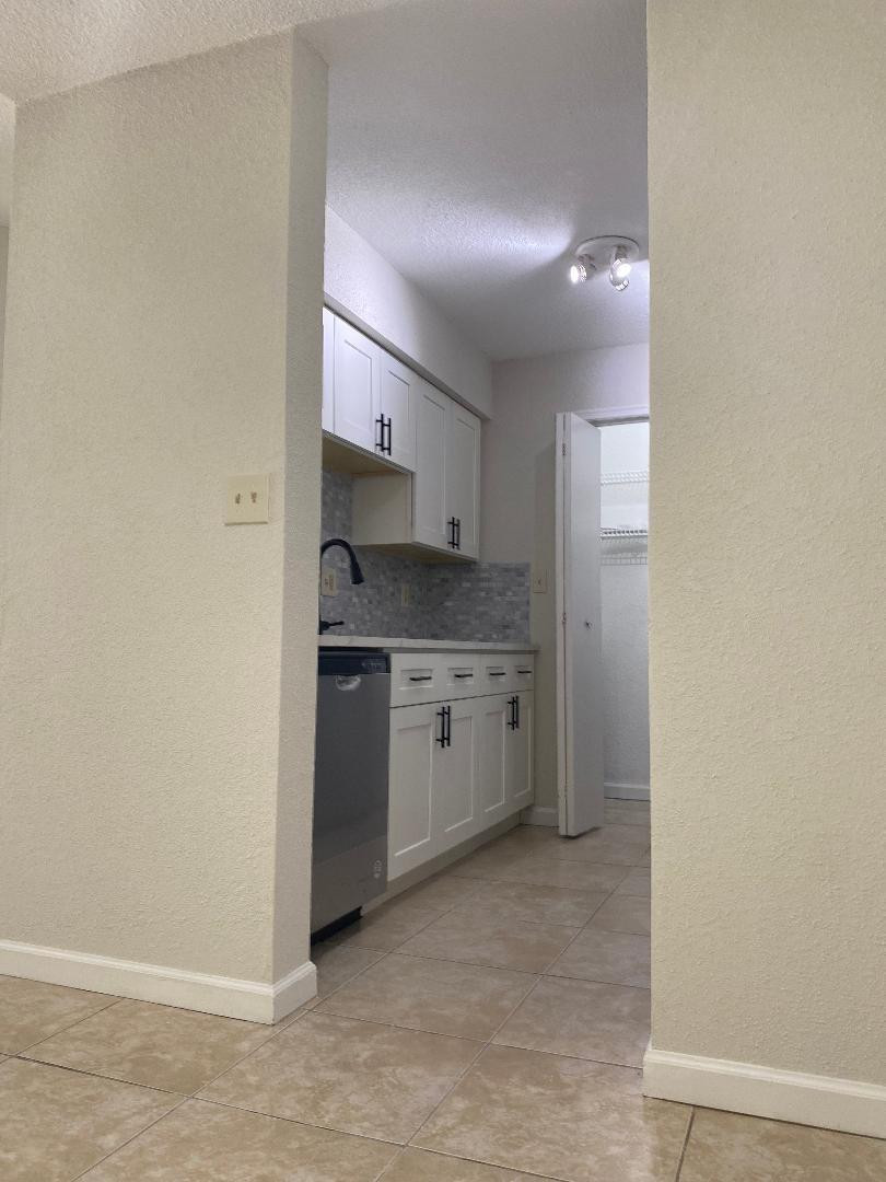 755 Riverside Drive, Unit 1337 Coral Springs, FL 33071 - Photo 8 of 37 a kitchen with a stove a sink and a refrigerator