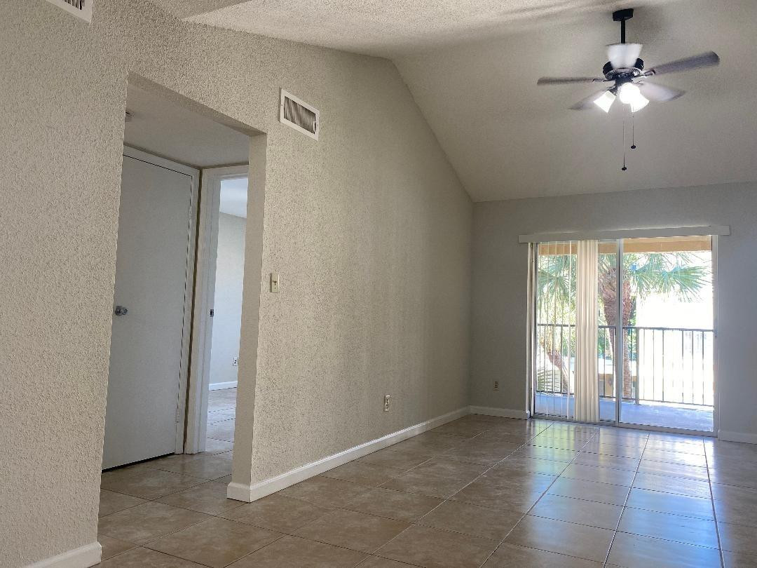 755 Riverside Drive, Unit 1337 Coral Springs, FL 33071 - Photo 10 of 37 an empty room with wooden floor fan and windows
