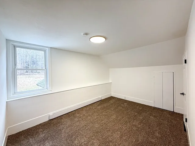 an empty room with a empty space and windows