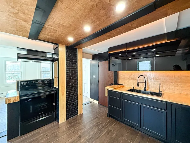 a kitchen with granite countertop a sink and cabinets