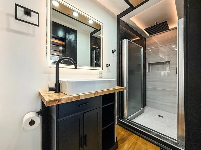 a bathroom with a shower and a sink