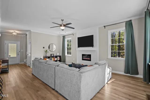 a living room with furniture a fireplace and a flat screen tv