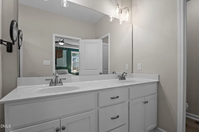 a bathroom with a double vanity sink and mirror