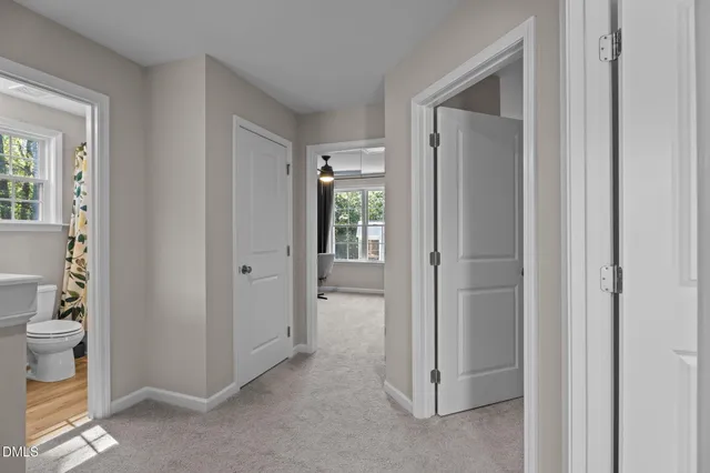 a view of a bathroom with closet and mirror
