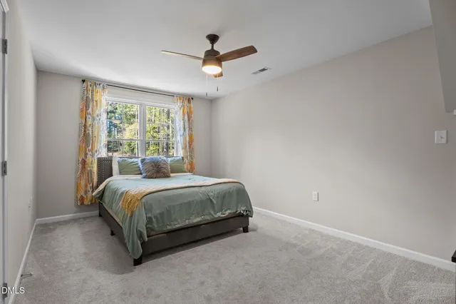 a spacious bedroom with a bed and window