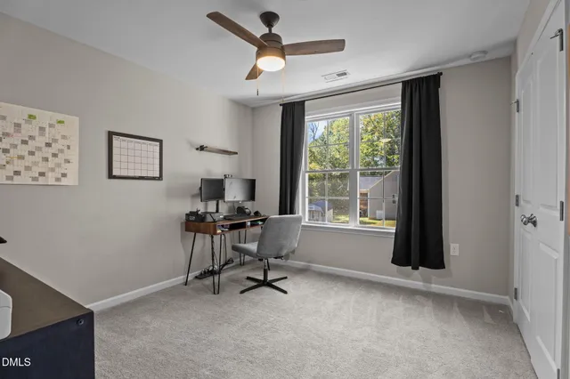 a work room with furniture and a large window