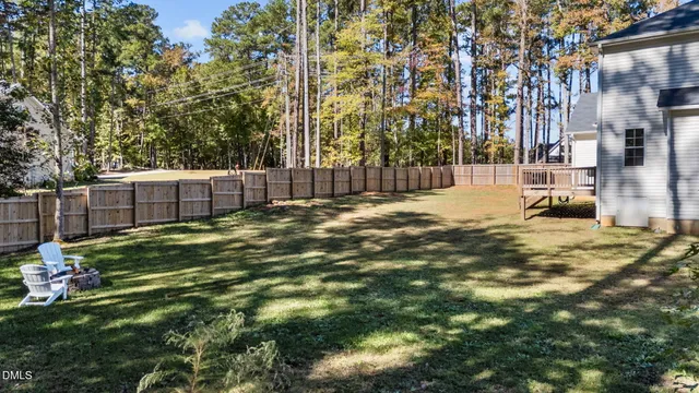 a view of a backyard with large trees