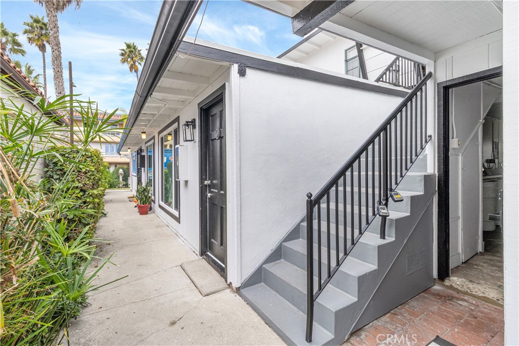 320 7th Street Seal Beach, CA 90740 - Photo 5 of 7 a view of a porch with wooden floor and staircase