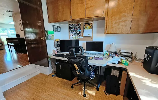 a view of a workspace with furniture and a rug
